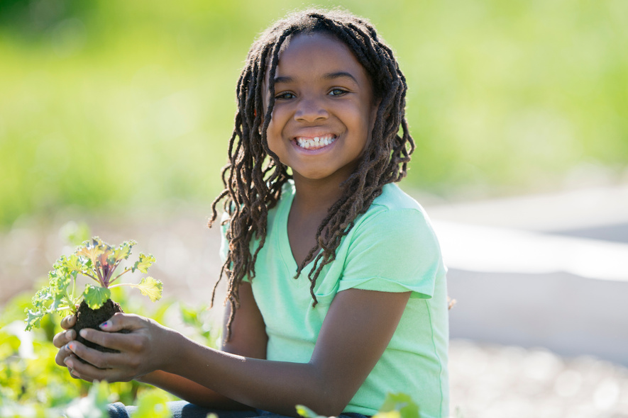Happy Child Planting a Garden